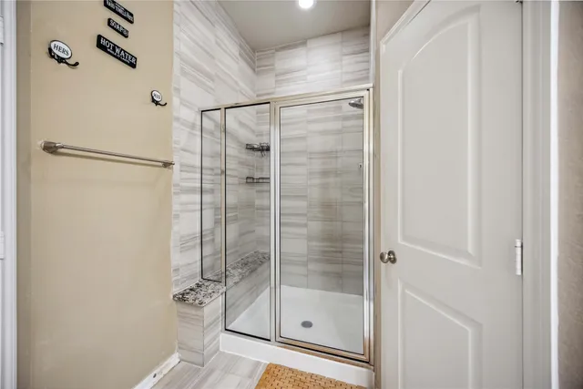 a bathroom with a glass shower door