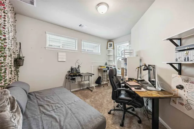 a bedroom with a workspace