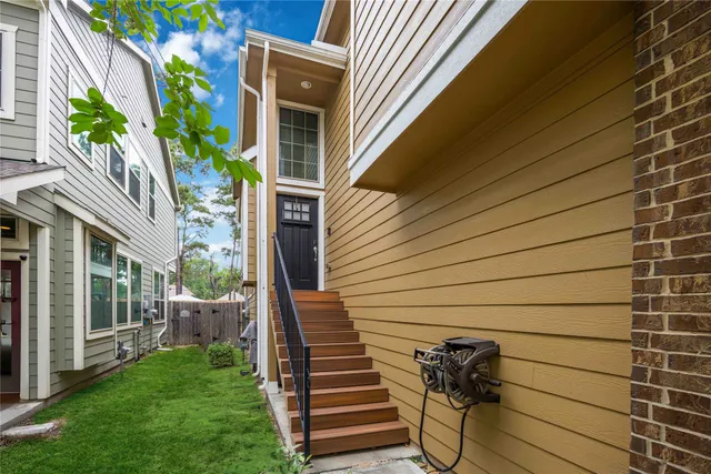 a view of a house with backyard porch and sitting area