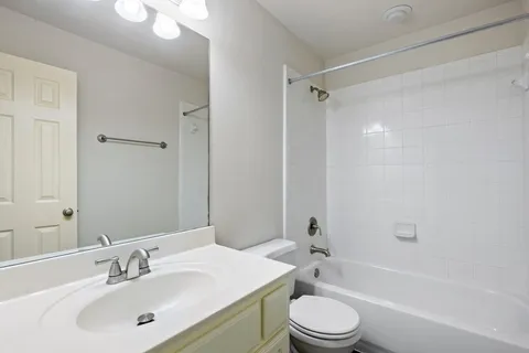 a bathroom with a sink a toilet and a bathtub