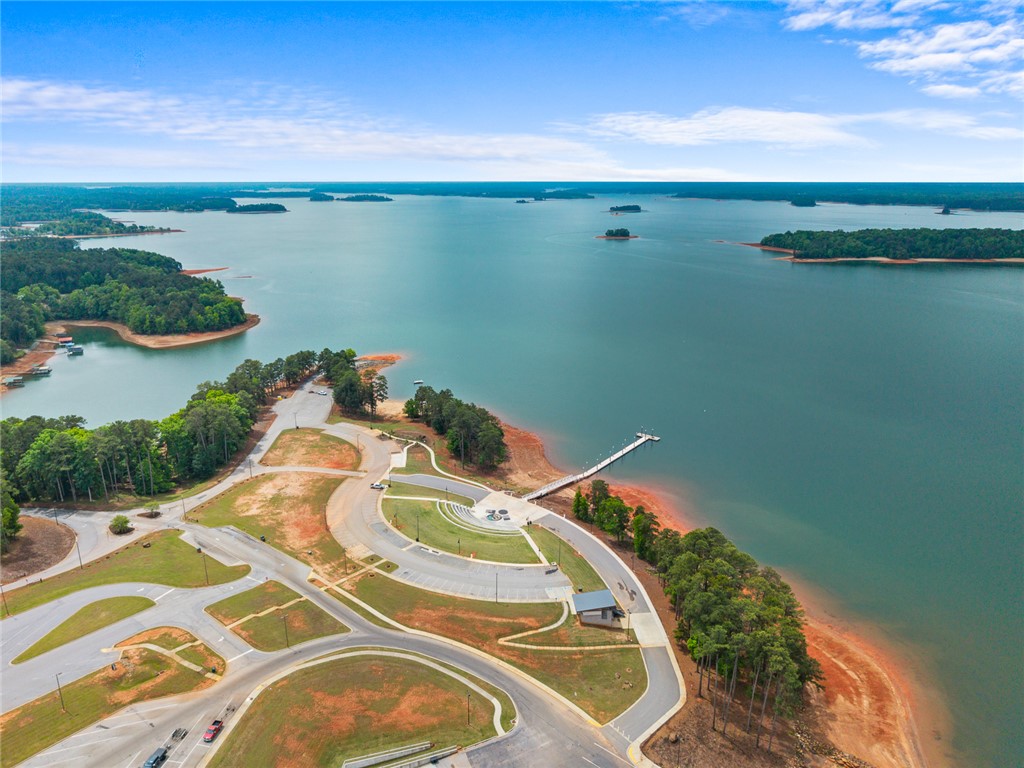 111 State Rd S-4-104 Anderson, SC 29626 - Photo 33 of 42 This aerial view showcases a vibrant lake with a boat launch, surrounded by lush trees and convenient paved roads.