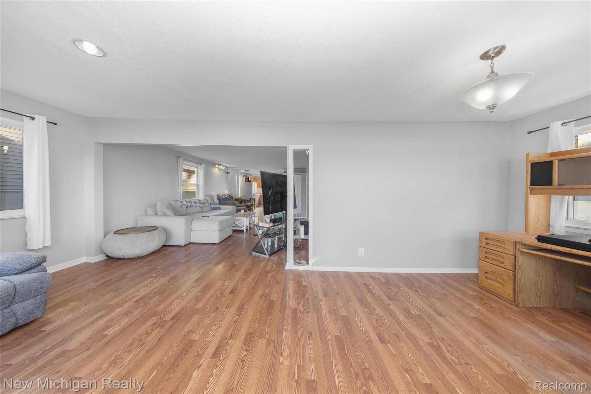 8665 Cooley Lake Road Commerce Township, MI 48382 - Photo 11 of 52 Living room with light wood-style flooring