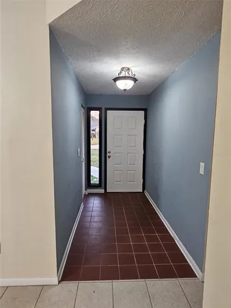 an entryway in a hall with a window