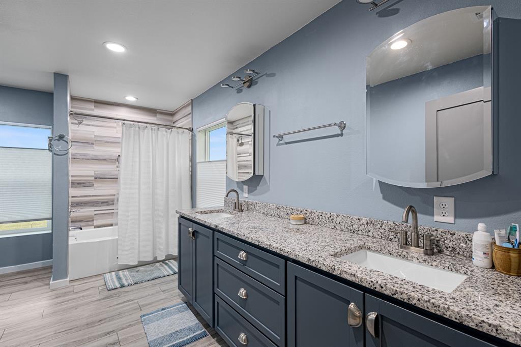 124 County Road 4511 Decatur, TX 76234 - Photo 21 of 39 a bathroom with a granite countertop sink and a mirror