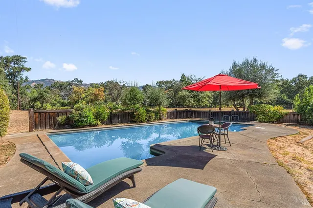a view of a room with furniture and a large window