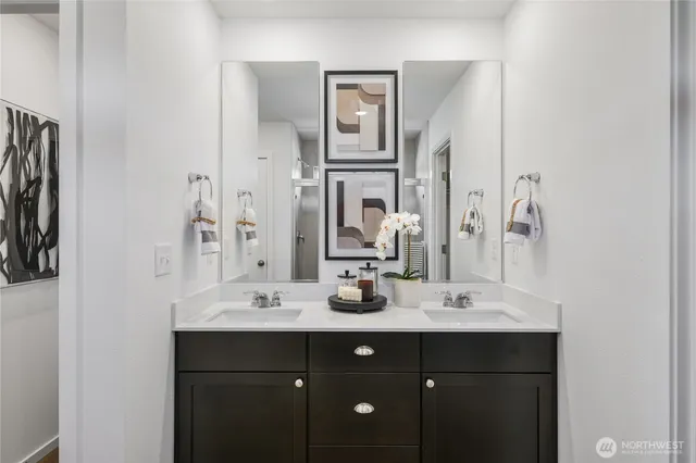 a bathroom with a double vanity sink and a mirror