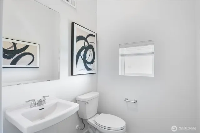 a white toilet sitting next to a bathroom sink
