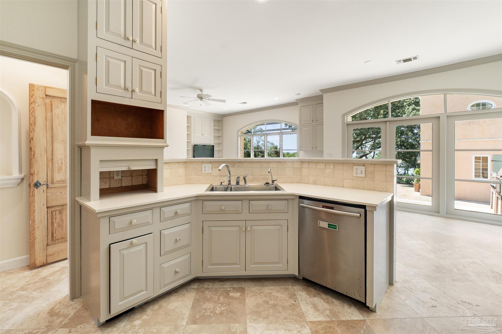 1725 E Lane Pensacola, FL 32501 - Photo 20 of 72 a kitchen with cabinets and window
