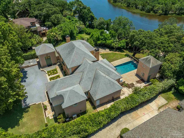 an aerial view of residential house with outdoor space and swimming pool
