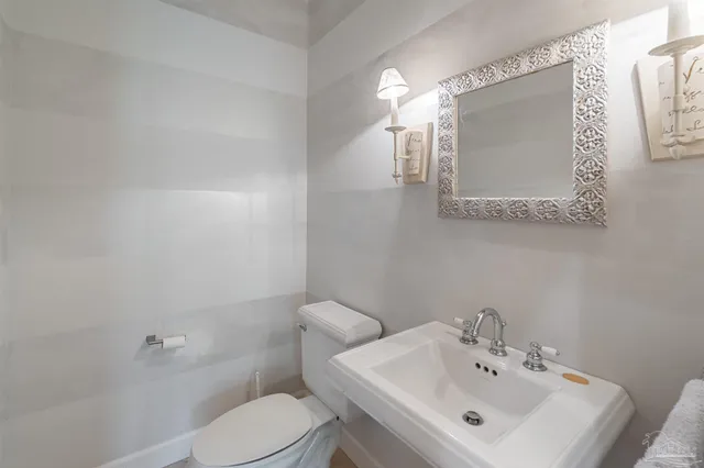 a white toilet sitting next to a bathroom sink