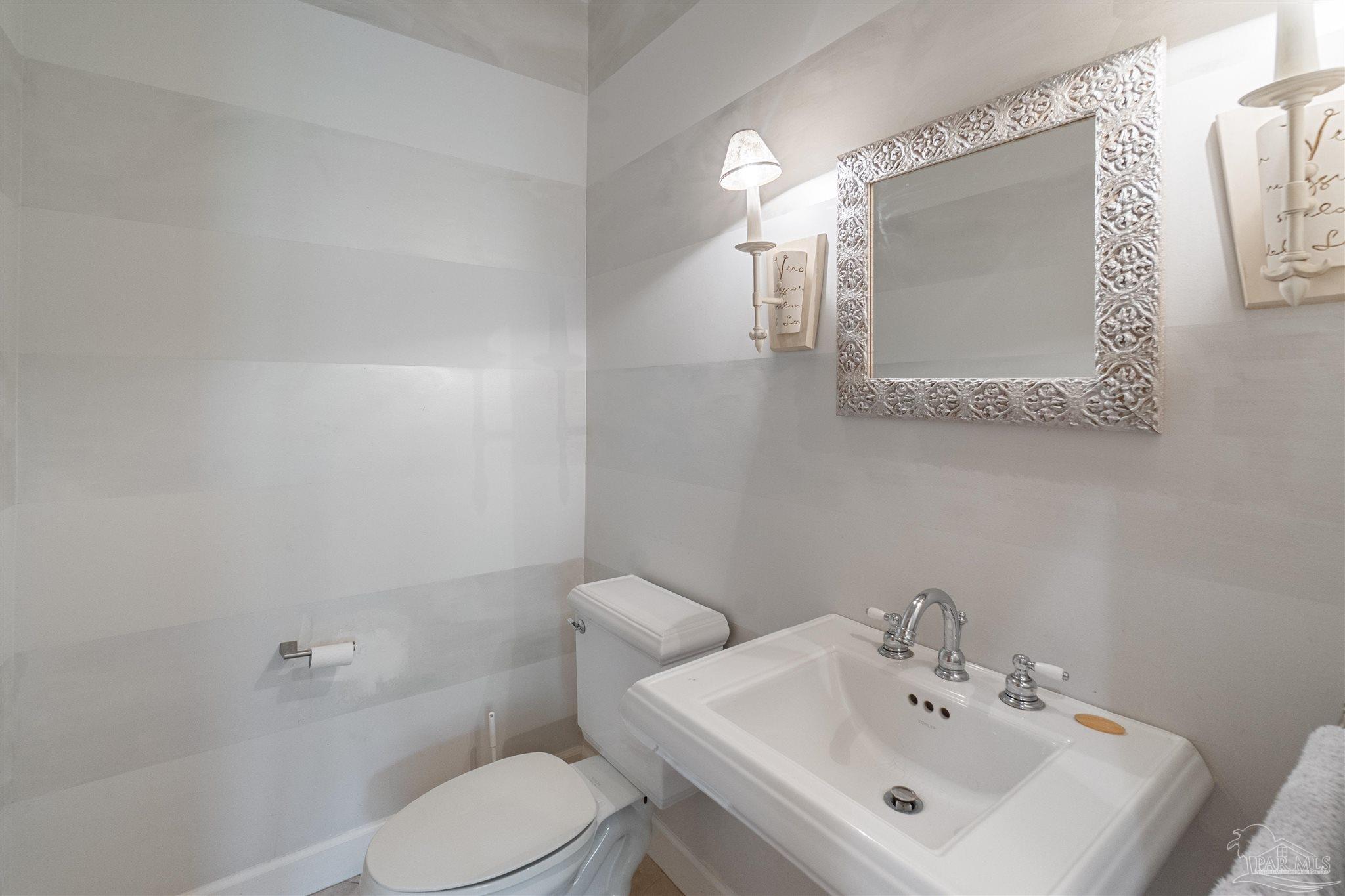 1725 E Lane Pensacola, FL 32501 - Photo 25 of 72 a bathroom with a toilet sink and mirror