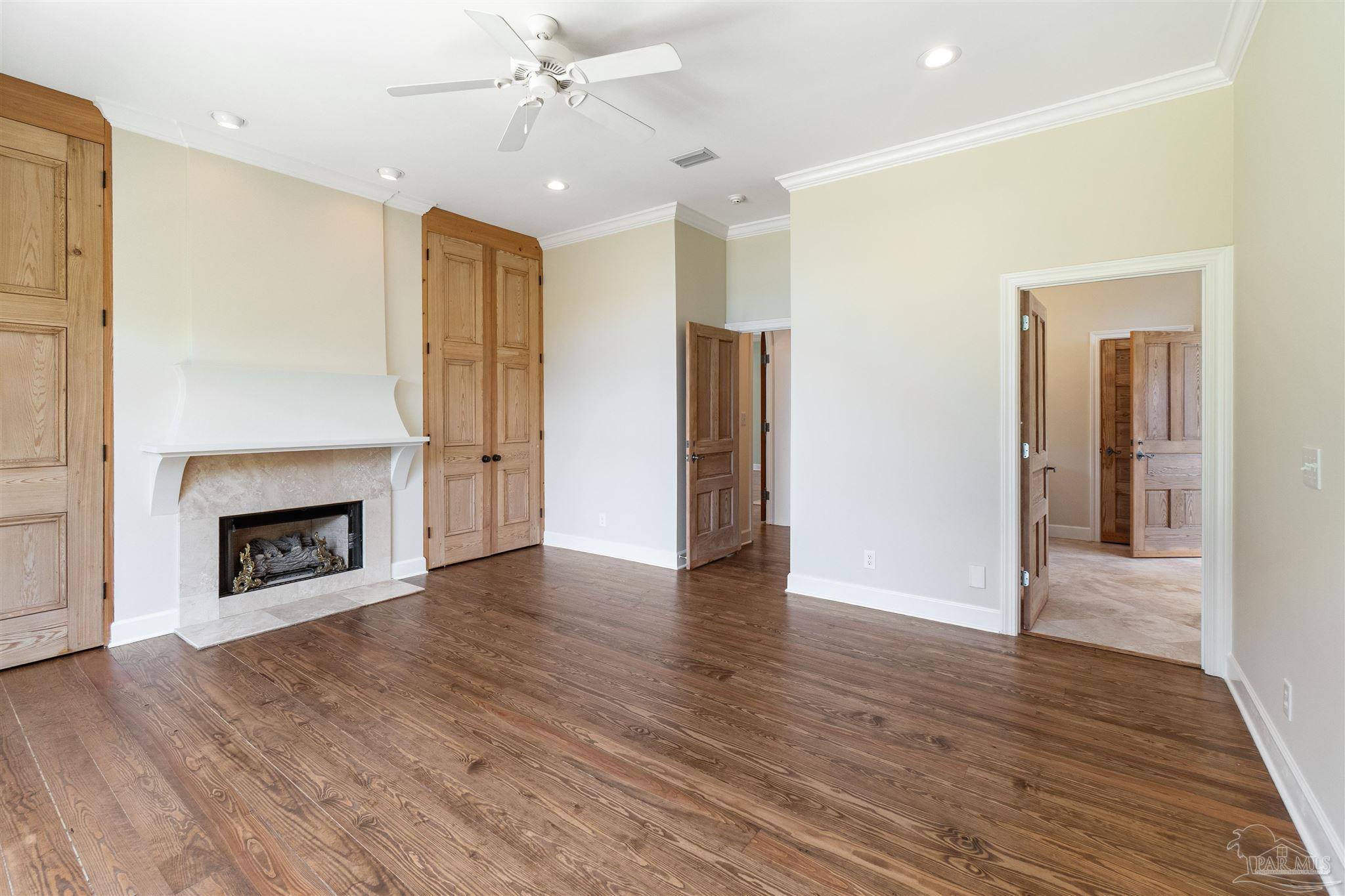 1725 E Lane Pensacola, FL 32501 - Photo 27 of 72 an empty room with wooden floor a fireplace and entryway