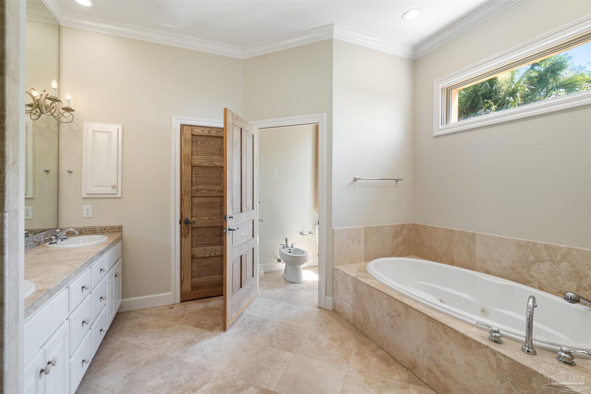 1725 E Lane Pensacola, FL 32501 - Photo 30 of 72 a bathroom with a tub a toilet and a double vanity sink