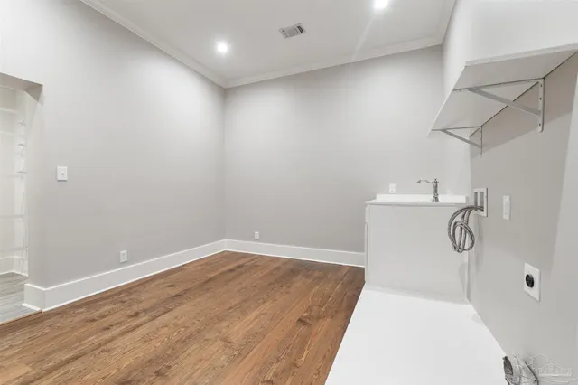 a view of a room with wooden floor and a window