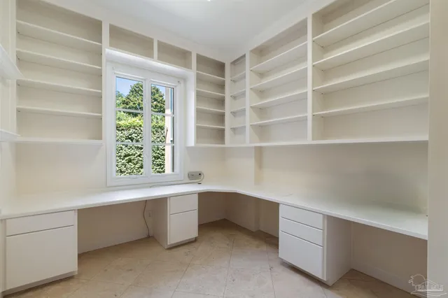 a view of a room with wooden floors and white walls