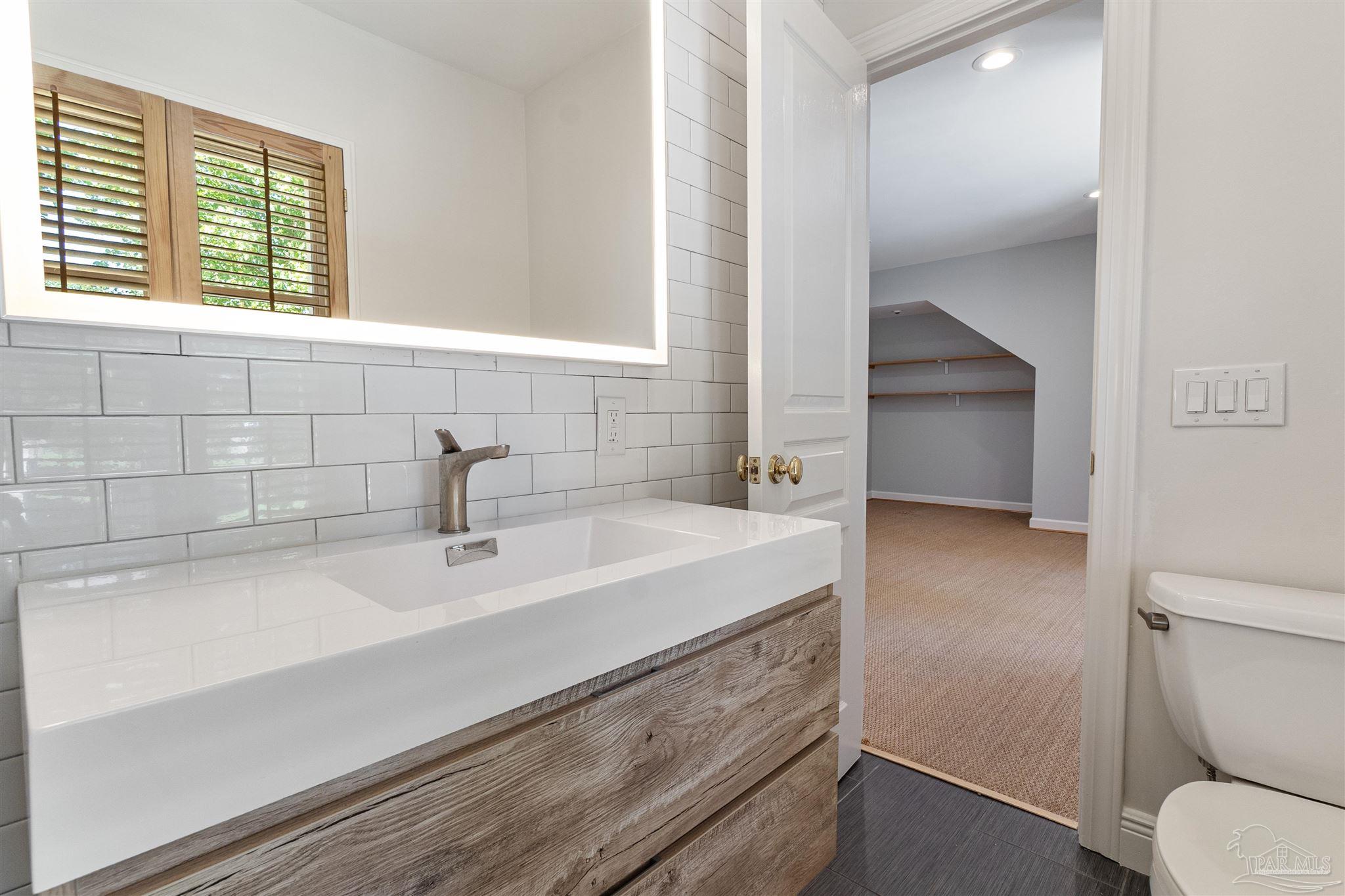 1725 E Lane Pensacola, FL 32501 - Photo 48 of 72 a bathroom with a sink and a toilet