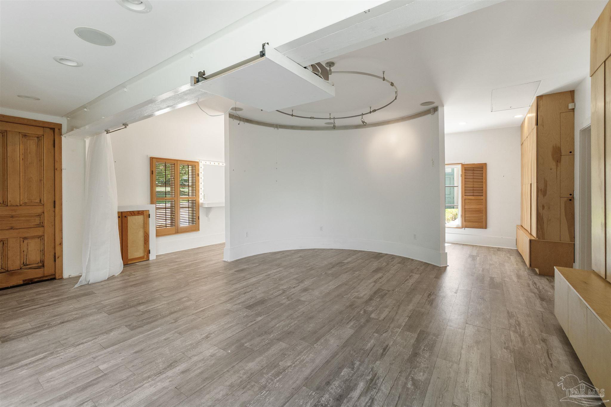 1725 E Lane Pensacola, FL 32501 - Photo 49 of 72 a view of an empty room with wooden floor and a window