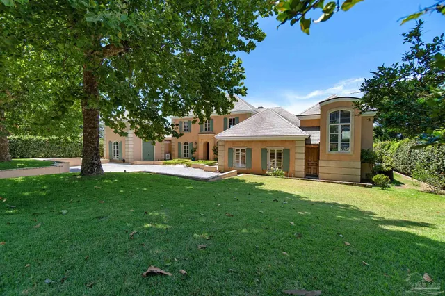 a front view of a house with yard and green space
