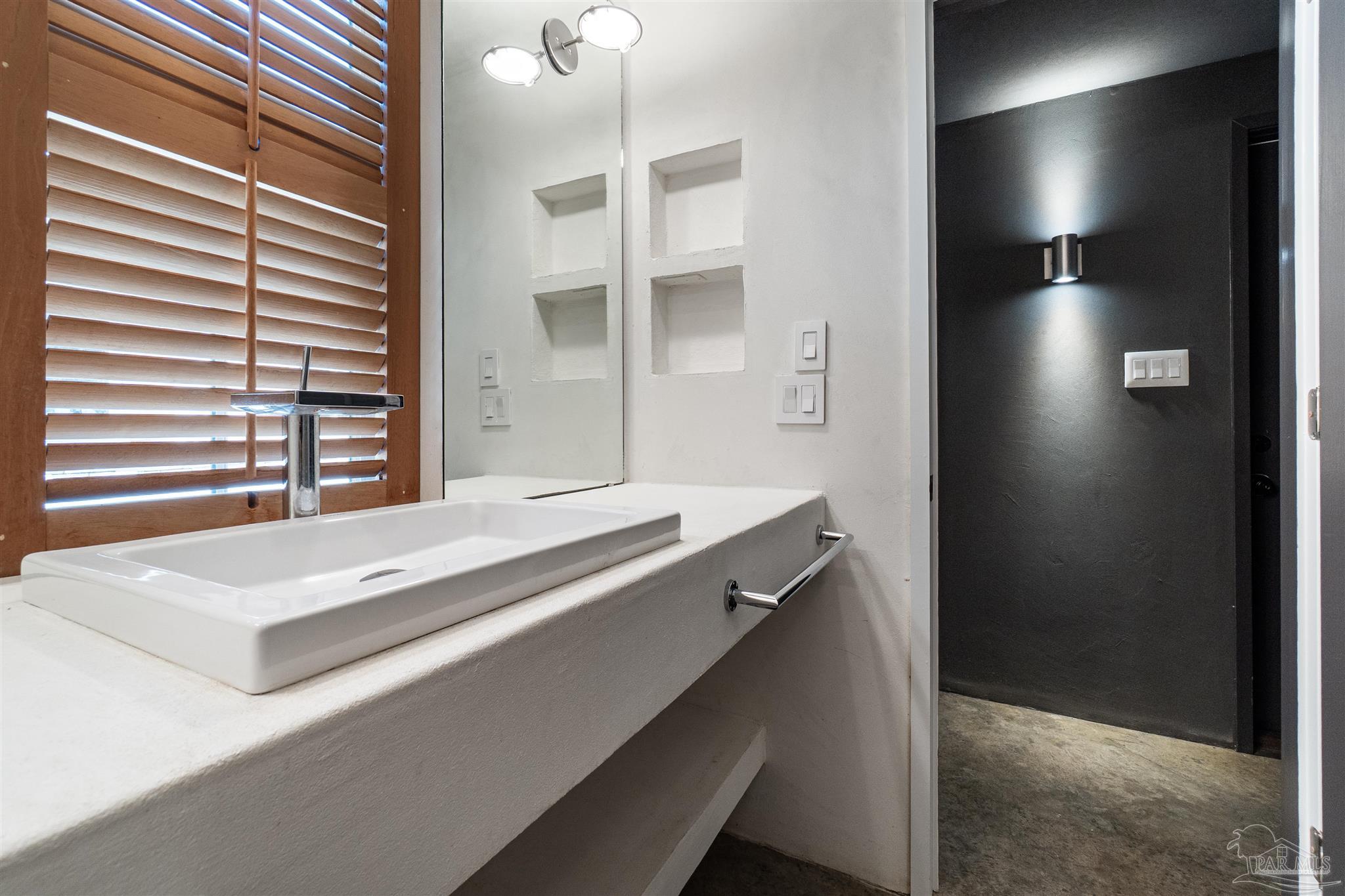 1725 E Lane Pensacola, FL 32501 - Photo 56 of 72 a view of bathroom with a sink and a mirror