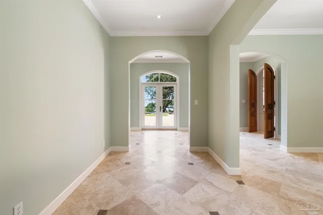 an empty room with windows and wooden floor