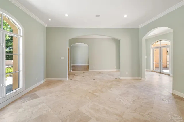 a view of an empty room with wooden floor and a fireplace