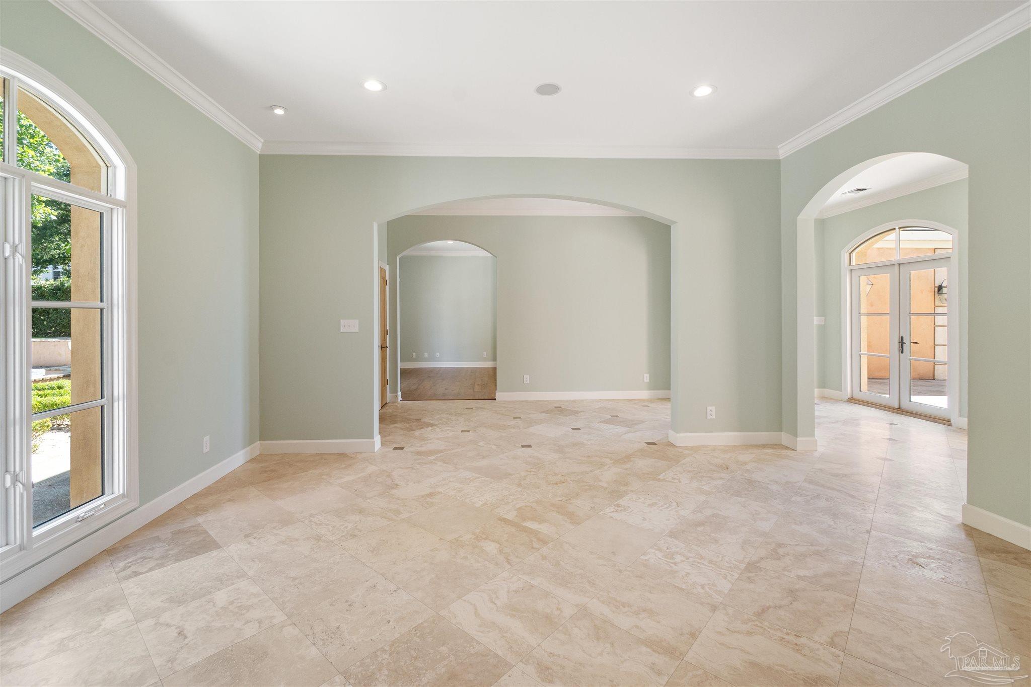 1725 E Lane Pensacola, FL 32501 - Photo 9 of 72 an empty room with windows and wooden floor