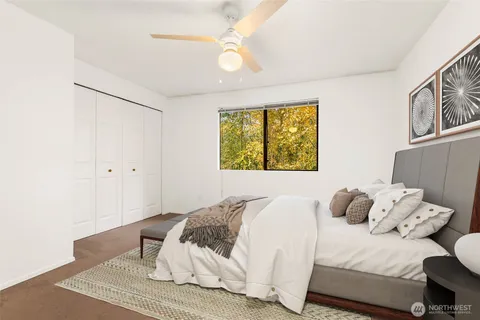 a bedroom with a bed and wooden floor