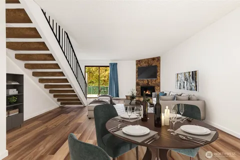 a view of a dining room with furniture wooden floor and chandelier