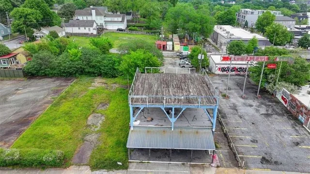 an aerial view of a house with a garden and lake view