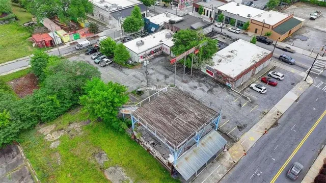 an aerial view of a house with a yard