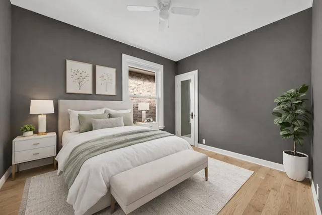 a bedroom with a bed and a potted plant