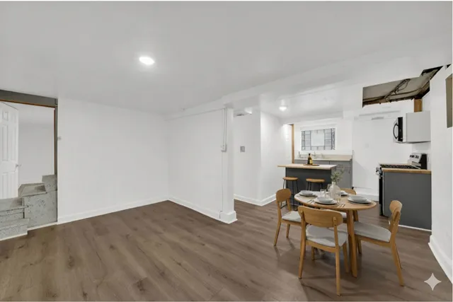 a view of kitchen with furniture and wooden floor