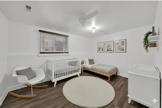 a bedroom with a bed and a chair