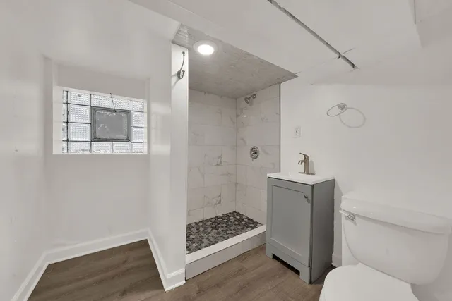 a bathroom with a sink toilet and shower