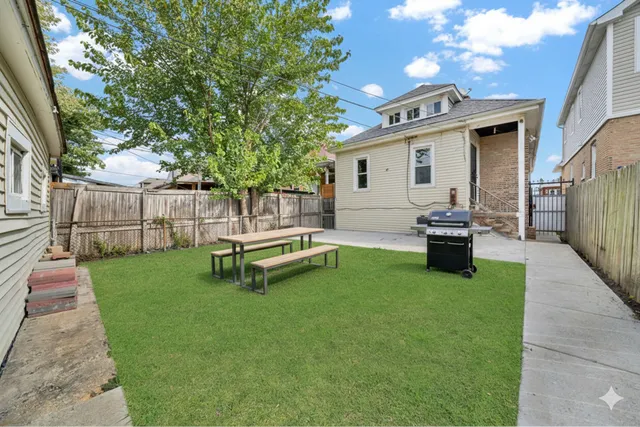 a view of a house with backyard porch and sitting area