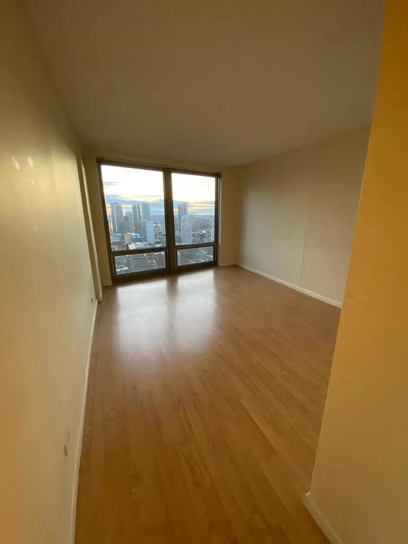 440 North Wabash Avenue, Unit 3703 Chicago, IL 60611 - Photo 15 of 27 an empty room with wooden floor and windows