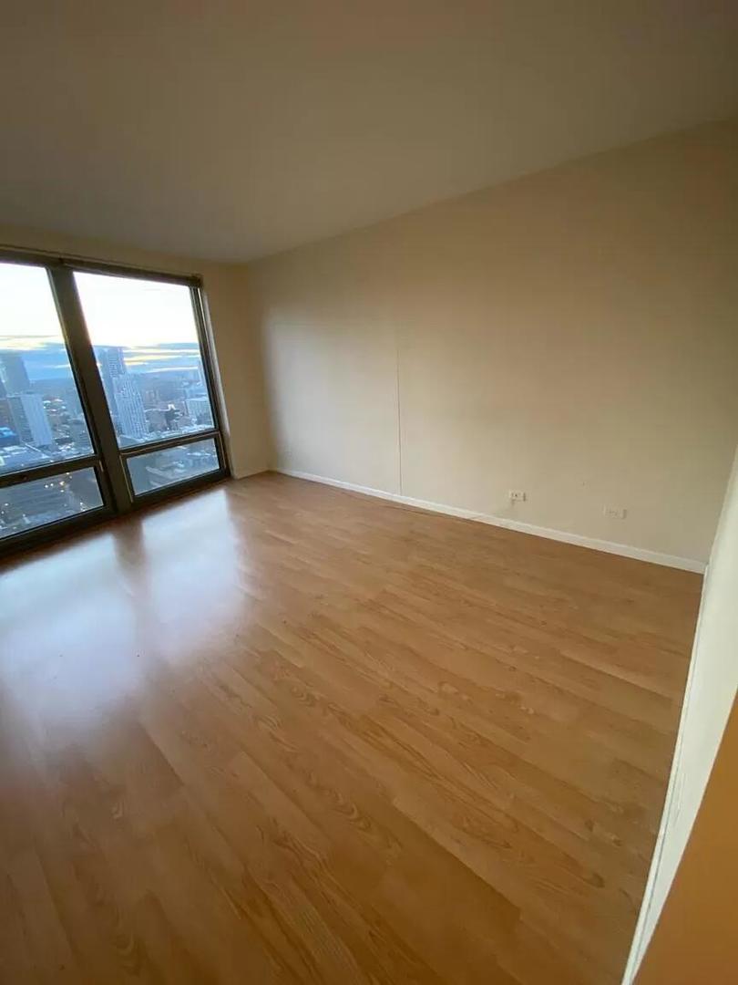 440 North Wabash Avenue, Unit 3703 Chicago, IL 60611 - Photo 18 of 27 a view of an empty room and wooden floor