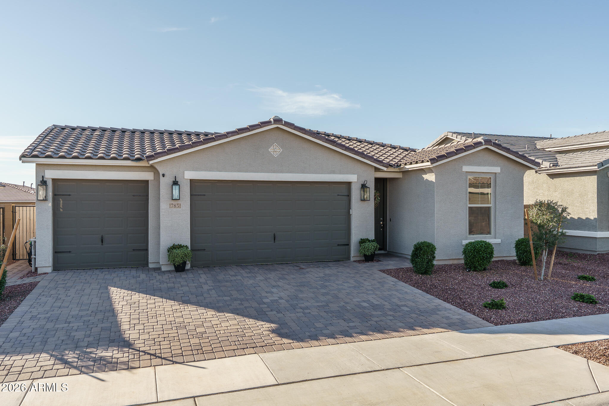 17851 West Red Fox Road Surprise, AZ 85387 - Photo 1 of 42 a front view of a house with garden