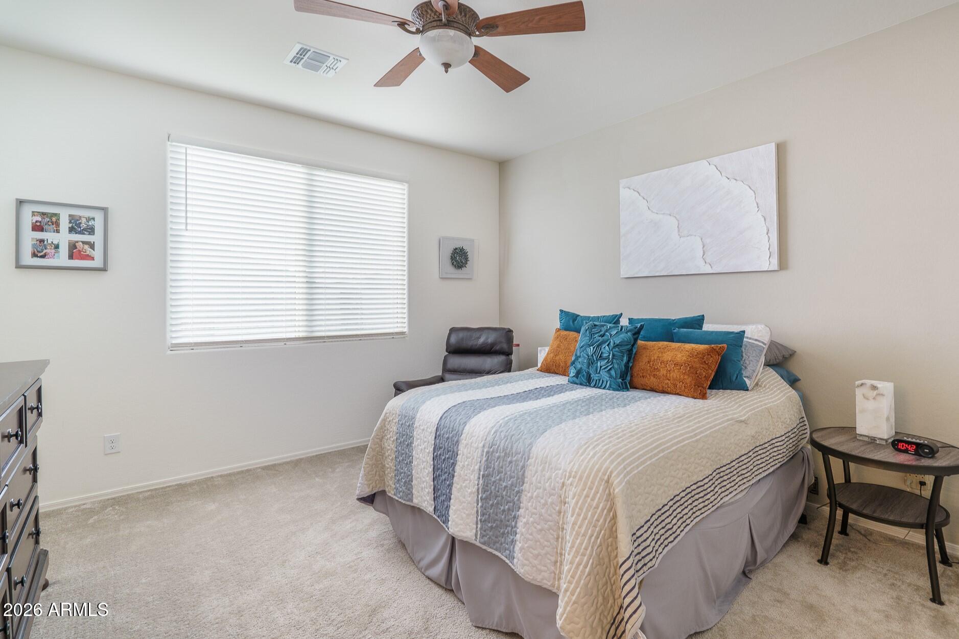 17851 West Red Fox Road Surprise, AZ 85387 - Photo 12 of 42 a bedroom with a bed and window