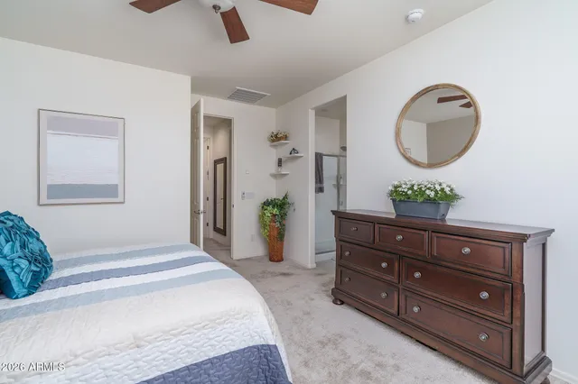 a bedroom with a bed and a potted plant