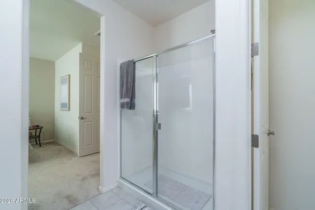a bathroom with a shower and a glass door