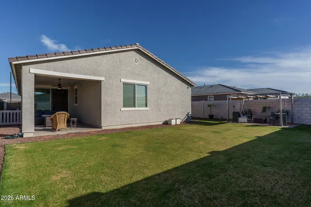 a view of a house with backyard and porch