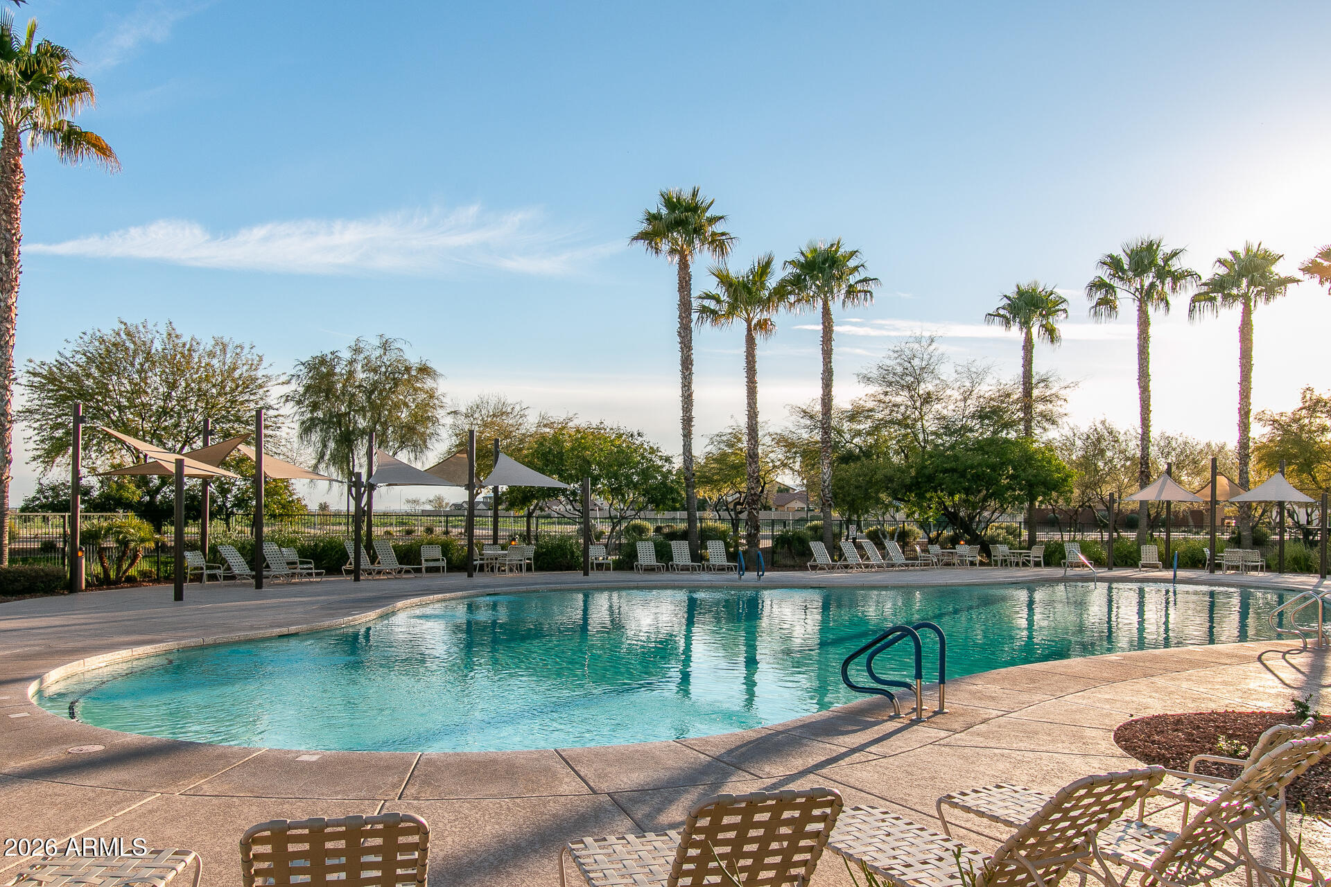 17851 West Red Fox Road Surprise, AZ 85387 - Photo 33 of 42 a view of a lake with a yard and large trees