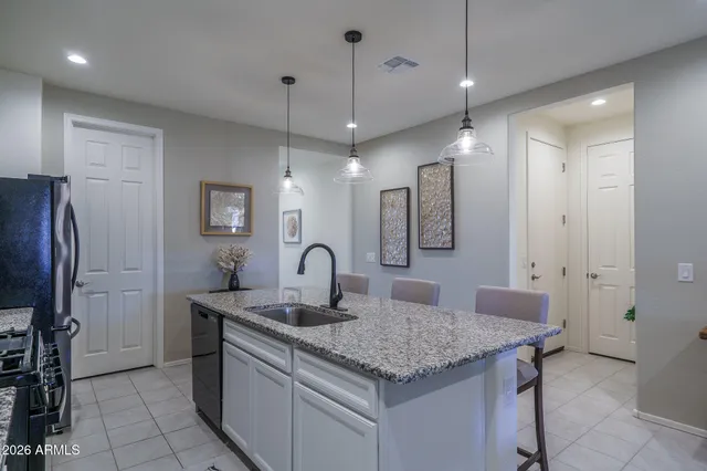 a kitchen with center island a sink stainless steel appliances and cabinets