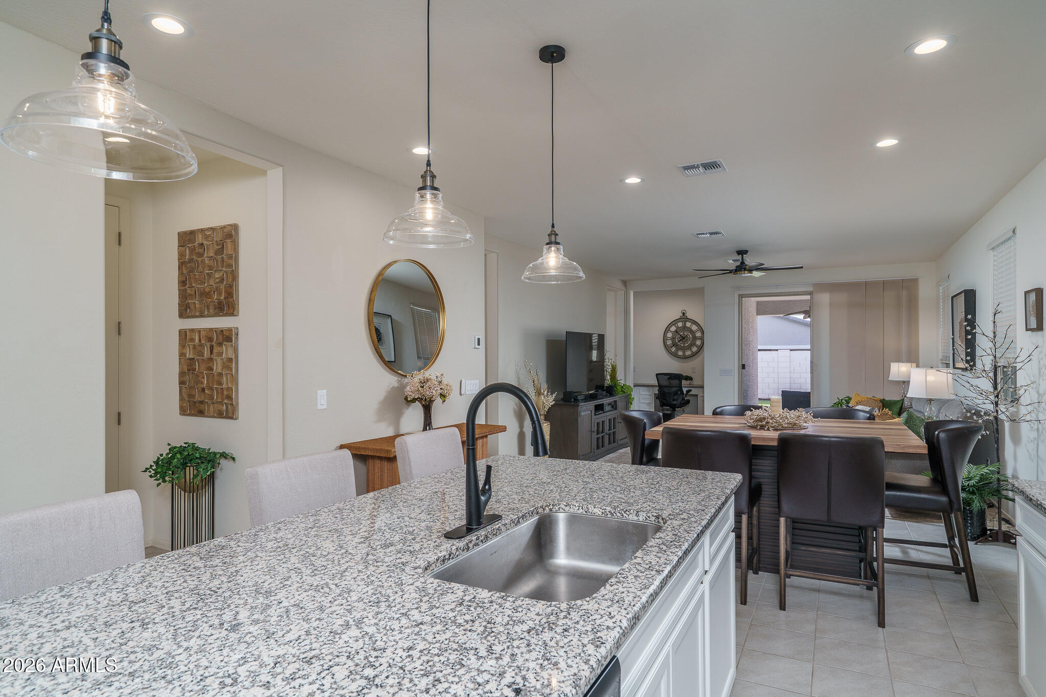 17851 West Red Fox Road Surprise, AZ 85387 - Photo 5 of 42 a kitchen with granite countertop a sink a counter top space and living room view