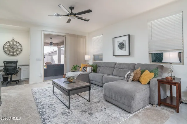 a living room with furniture a rug and a window