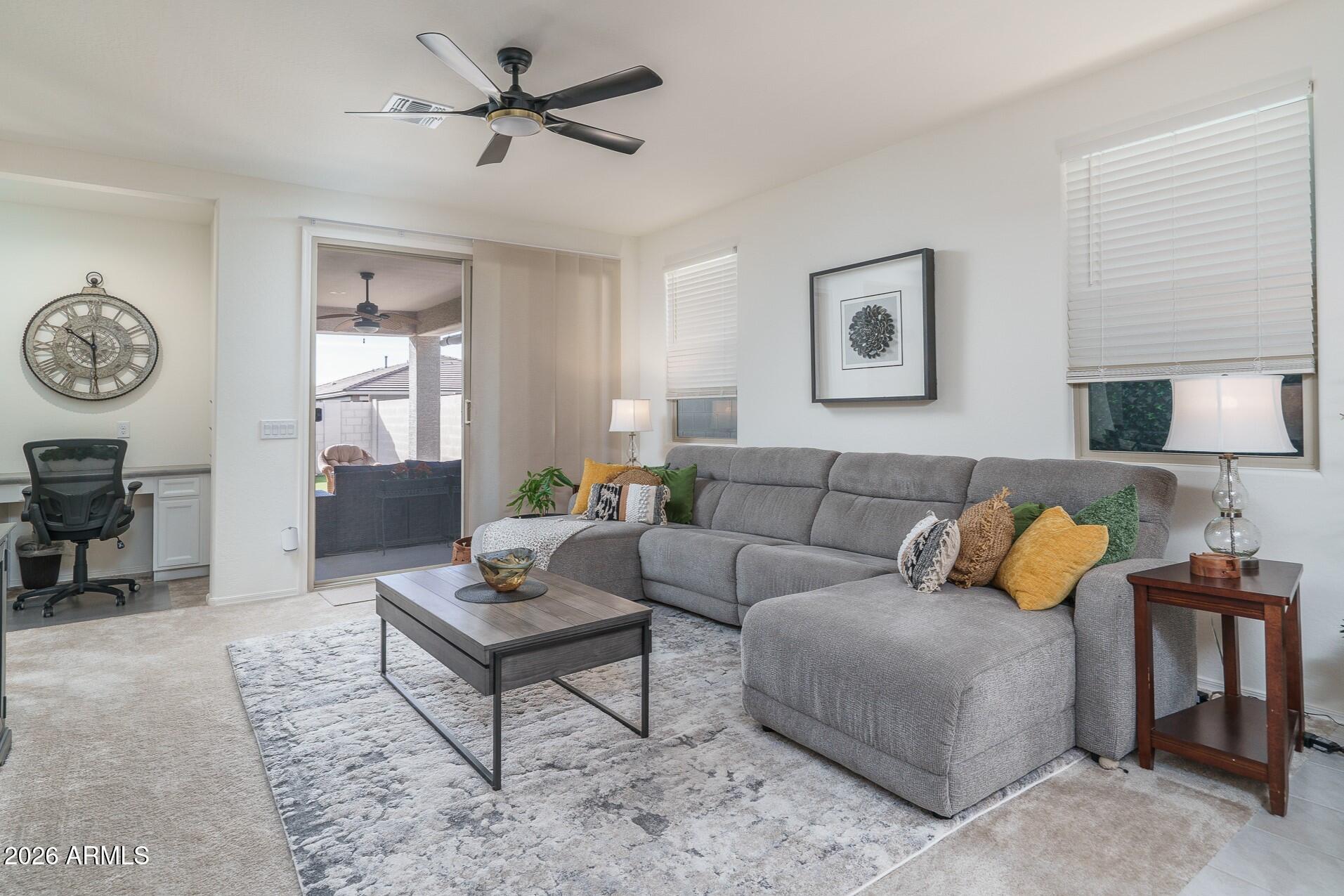17851 West Red Fox Road Surprise, AZ 85387 - Photo 8 of 42 a living room with furniture a rug and a window