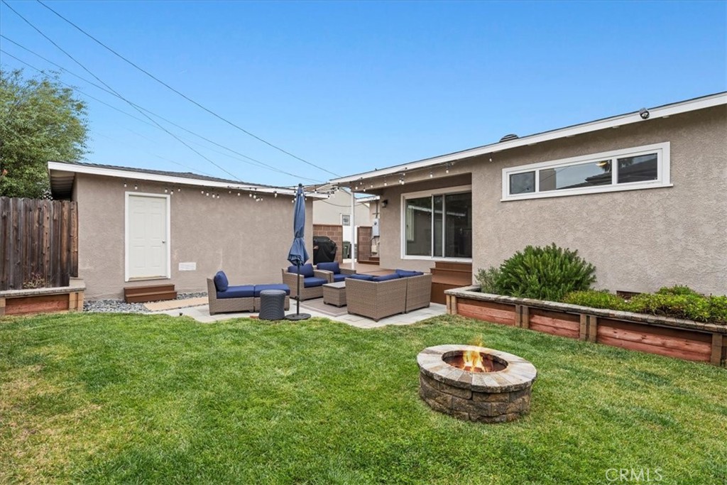 22643 Draille Drive Torrance, CA 90505 - Photo 27 of 33 a view of a backyard with table and chairs and wooden fence