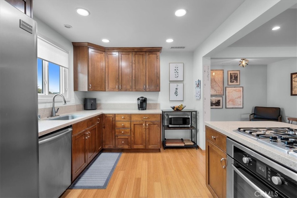 22643 Draille Drive Torrance, CA 90505 - Photo 9 of 33 a kitchen with a stove a sink and a refrigerator