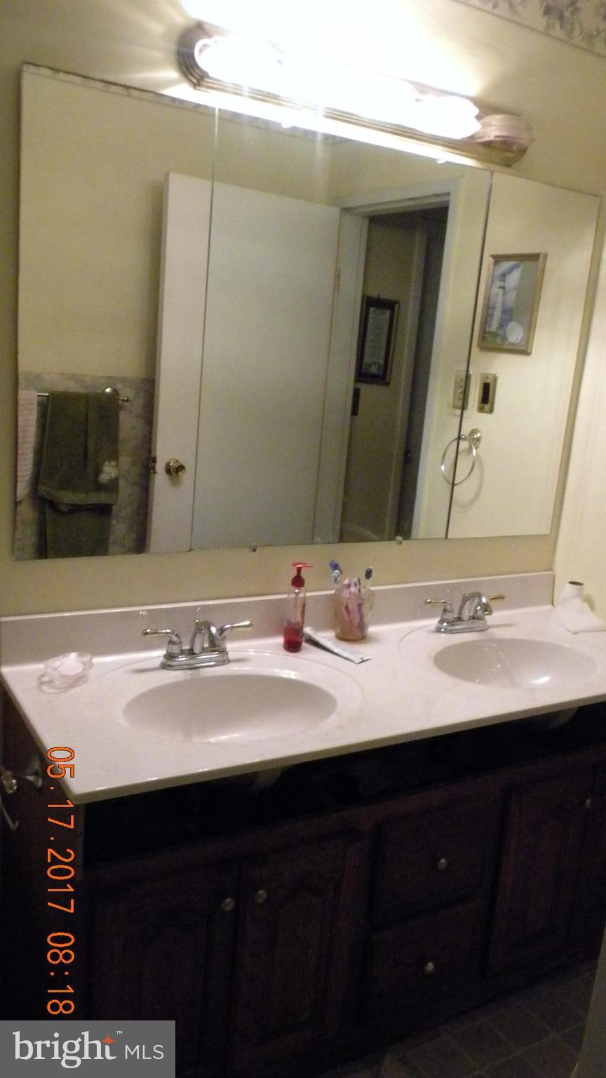 917 Prestwood Road Baltimore, MD 21228 - Photo 14 of 18 a bathroom with a sink and a mirror